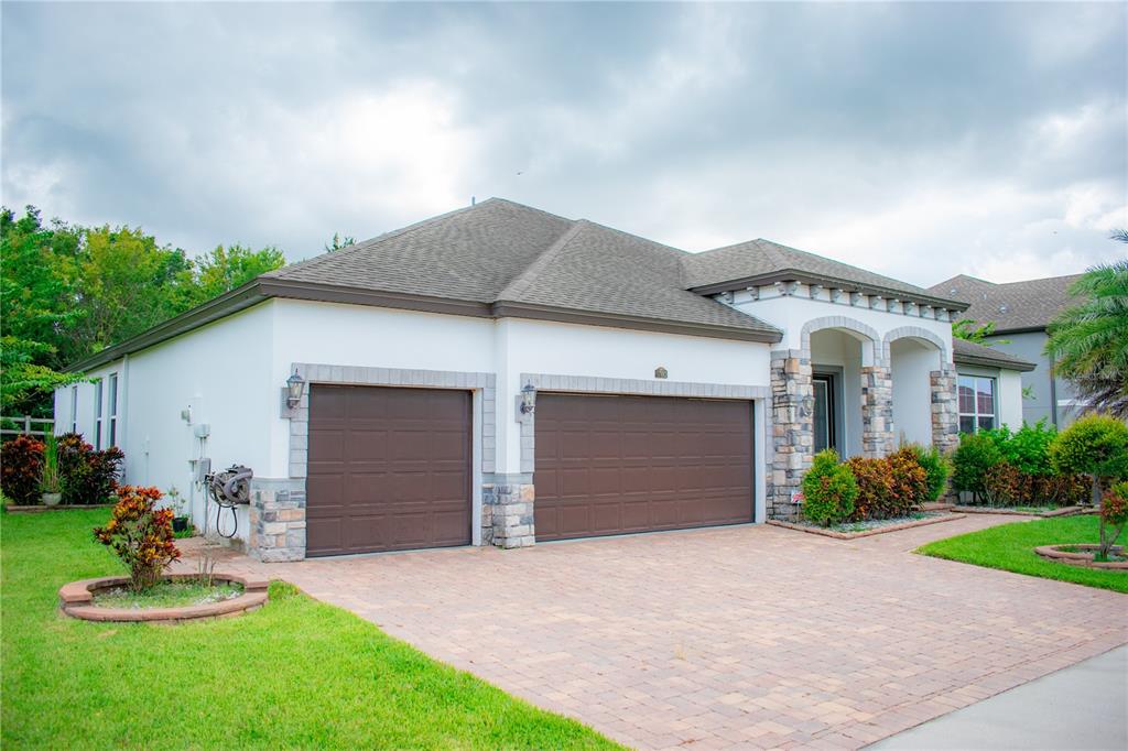 17993 Gourd Neck Loop Winter Garden, FL 34787 - Photo 2 of 29 a front view of a house with a garden and plants