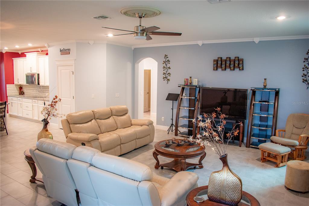 17993 Gourd Neck Loop Winter Garden, FL 34787 - Photo 7 of 29 a living room with furniture and a flat screen tv