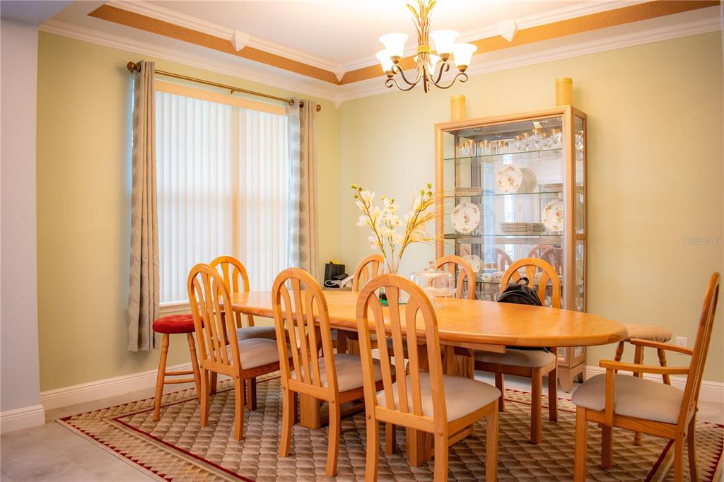 17993 Gourd Neck Loop Winter Garden, FL 34787 - Photo 9 of 29 a view of a dining room with furniture window and wooden floor