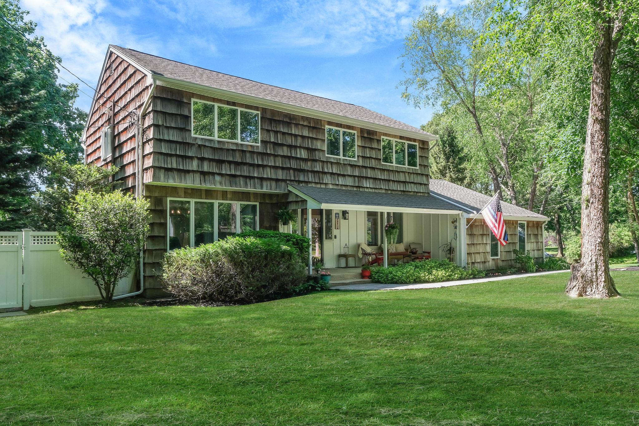 31 Blinker Light Road Stony Brook, NY 11790 - Photo 1 of 1 View of front facade featuring covered porch, a shingled roof, and board and batten siding