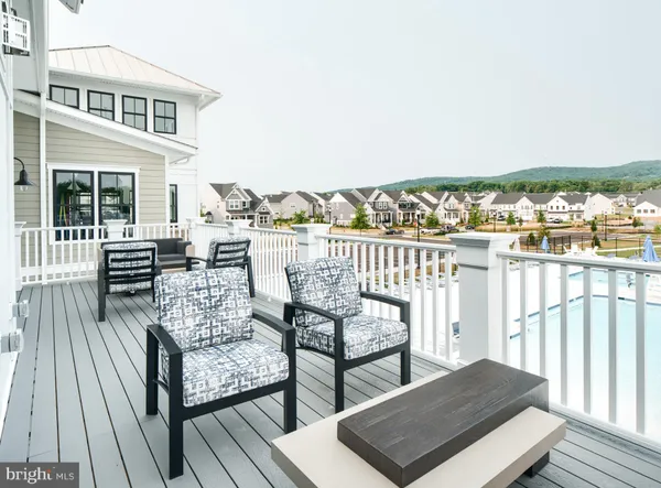 a view of a balcony with wooden floor and outdoor seating