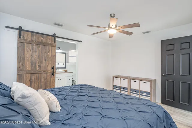 a bedroom with a bed dresser and a window