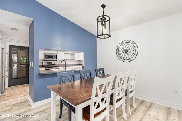 a kitchen with a dining table and chairs
