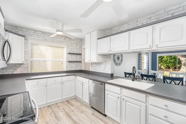a kitchen with cabinets a sink and appliances