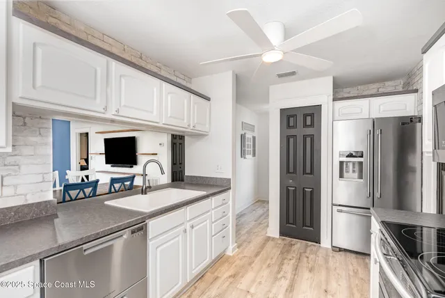 a kitchen with a refrigerator and a sink