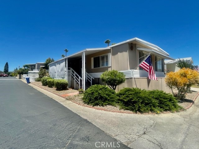 1120 East Mission Road, Unit 64 Fallbrook, CA 92028 - Photo 1 of 1 a front view of a house with a yard