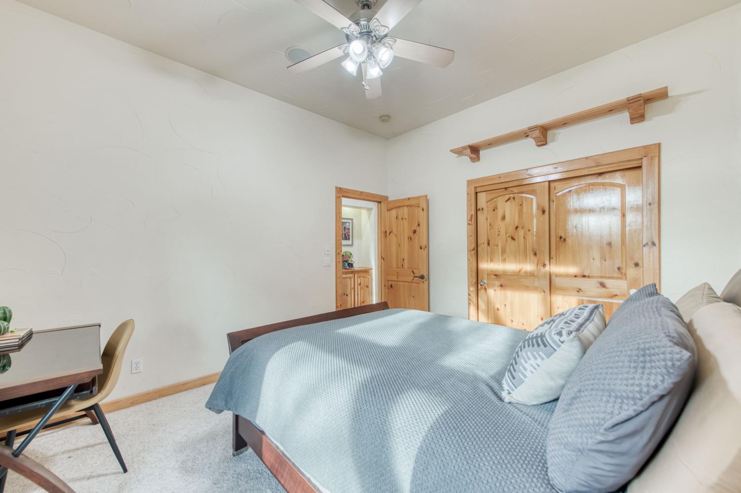 17433 El Dorado Madera, CA 93636 - Photo 16 of 49 a bedroom with a large bed and a chandelier