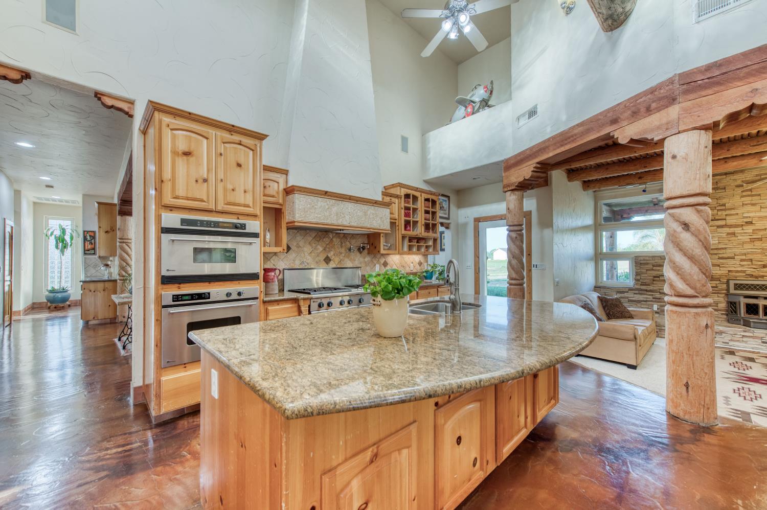 17433 El Dorado Madera, CA 93636 - Photo 33 of 49 a kitchen with stainless steel appliances granite countertop a stove and cabinets