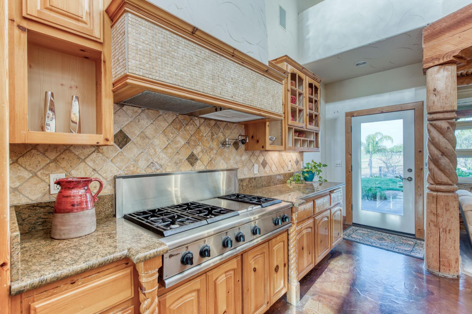 17433 El Dorado Madera, CA 93636 - Photo 34 of 49 a kitchen with stainless steel appliances granite countertop a stove and a wooden cabinets