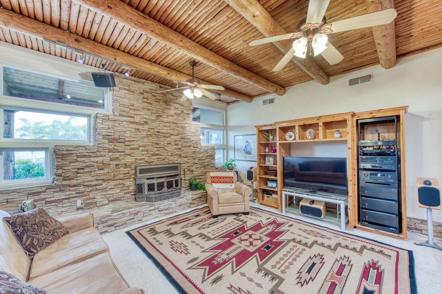 17433 El Dorado Madera, CA 93636 - Photo 36 of 49 a living room with a flat screen tv and a fireplace