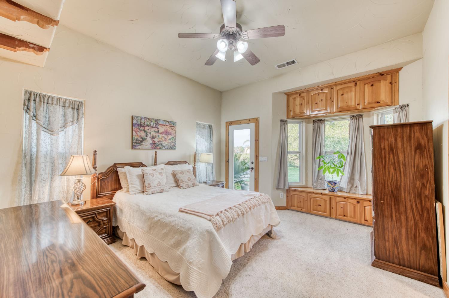 17433 El Dorado Madera, CA 93636 - Photo 45 of 49 a spacious bedroom with a large bed and a chandelier