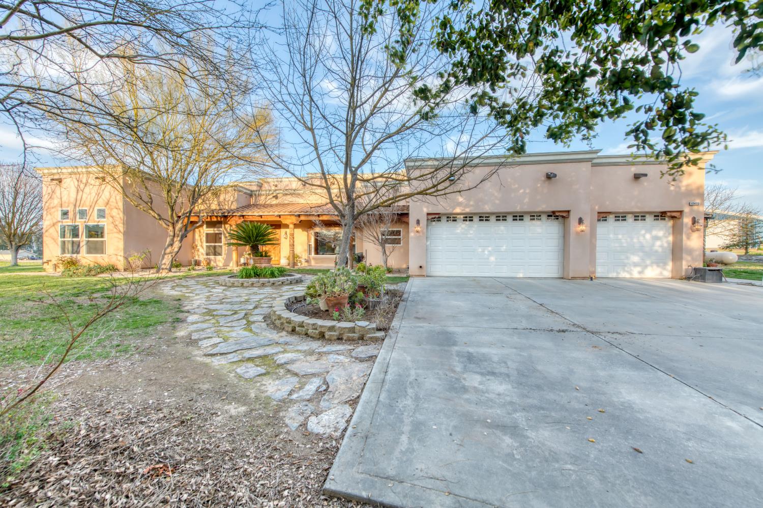 17433 El Dorado Madera, CA 93636 - Photo 49 of 49 a front view of a house with a yard and potted plants