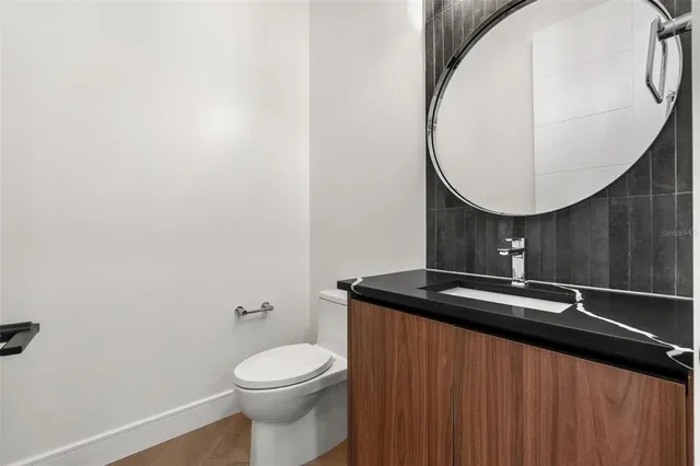 a bathroom with a sink a toilet and a mirror