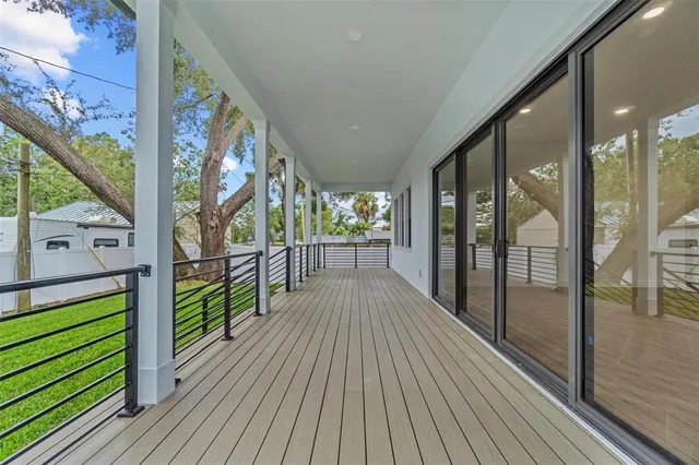 a view of a porch with wooden floor