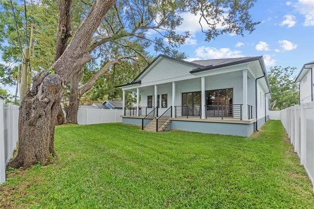 a view of house with yard and outdoor seating
