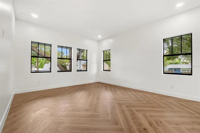 wooden floor in an empty room with a window
