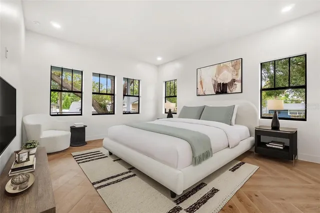 a bedroom with a large bed and a window