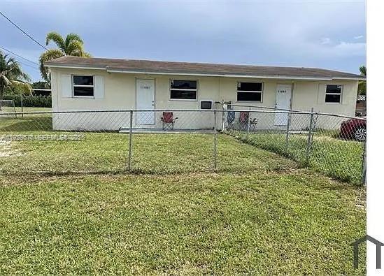 11800 Southwest 212th Street, Unit 11800 Miami, FL 33177 - Photo 1 of 14 a front view of house with yard
