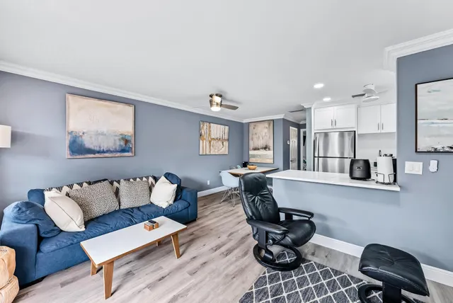 a living room with furniture and kitchen view