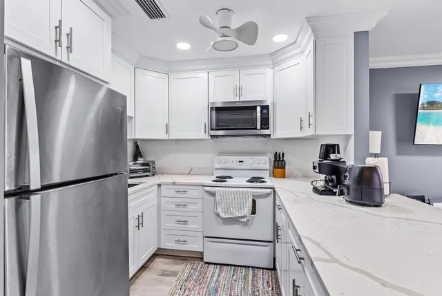 a kitchen with stainless steel appliances a refrigerator stove and microwave