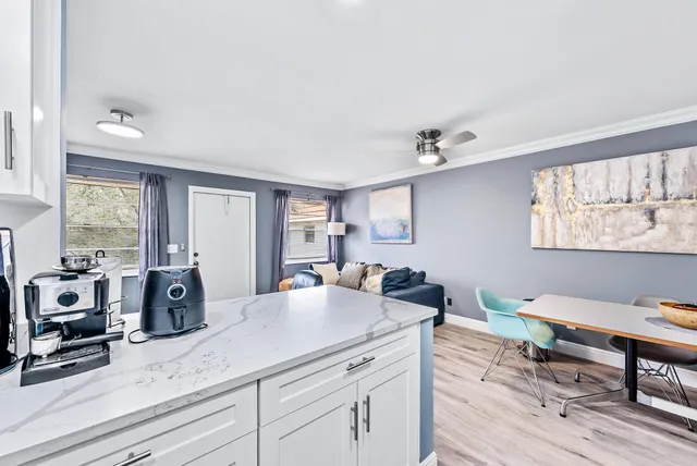 a view of living room with furniture and wooden floor