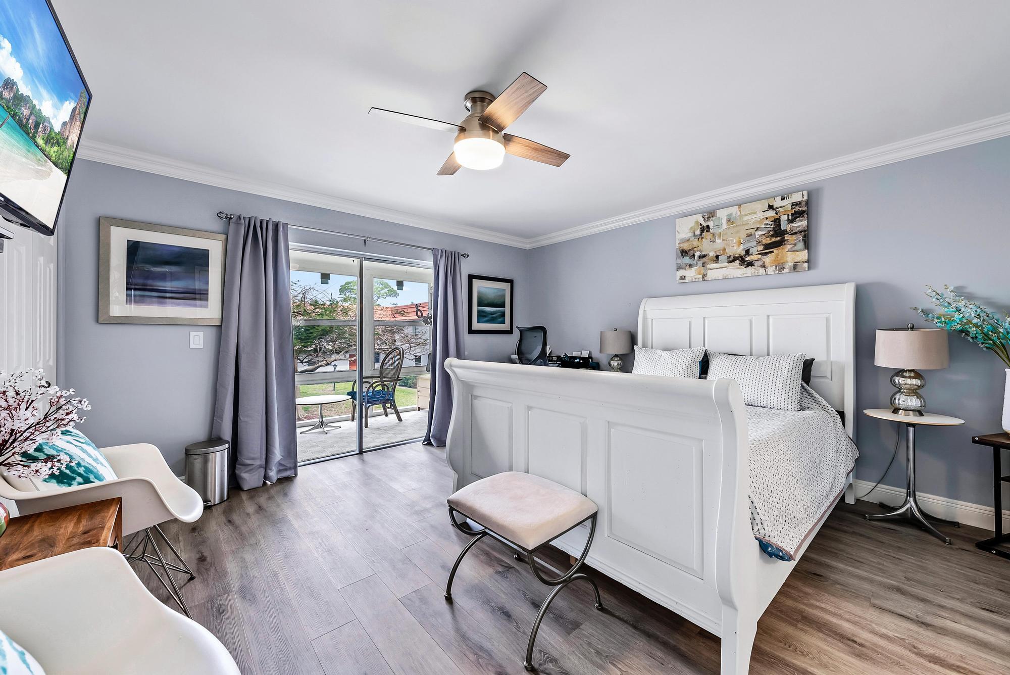 2600 Southeast Ocean Boulevard, Unit A11 Stuart, FL 34996 - Photo 7 of 12 a bedroom with a bed and wooden floor