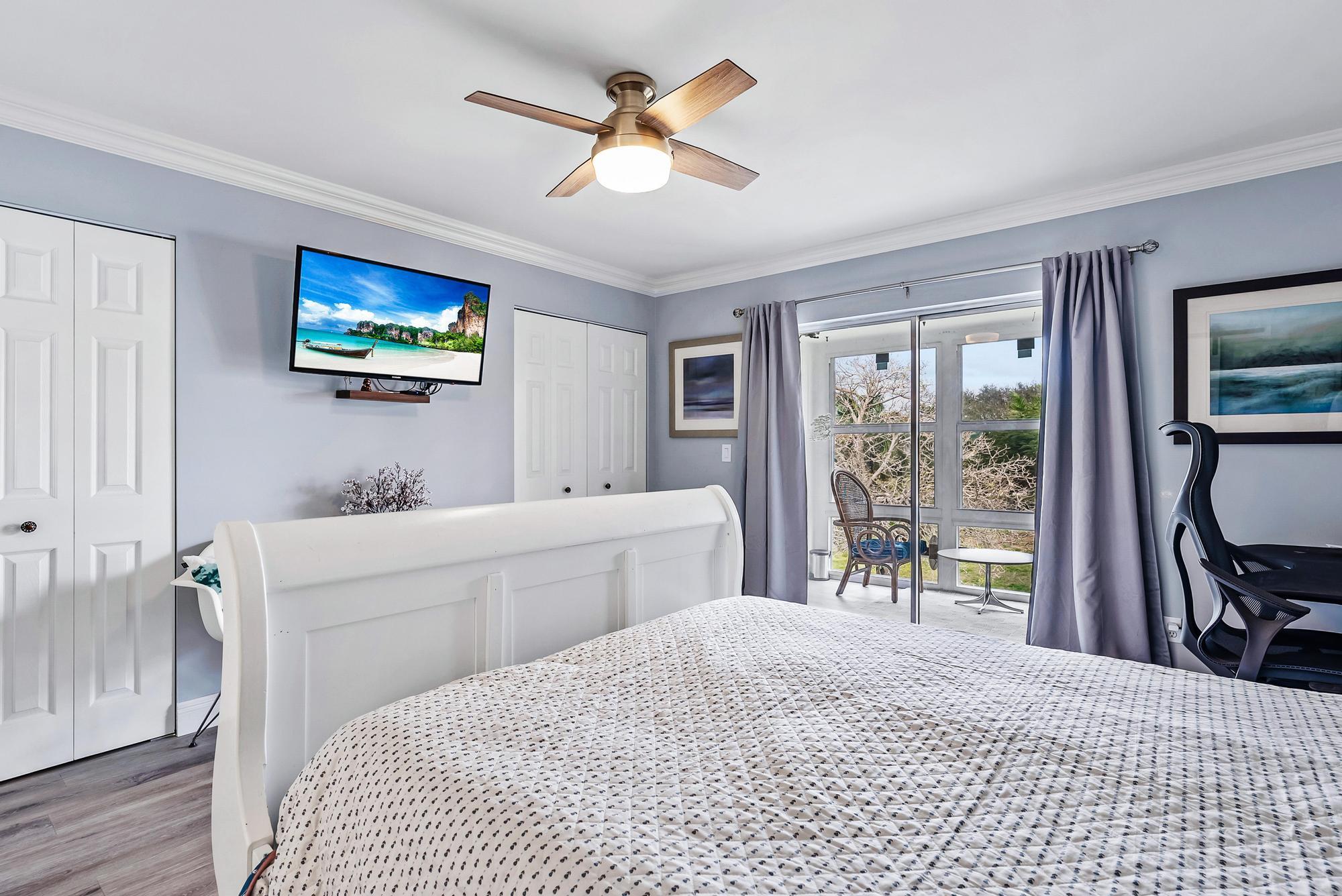 2600 Southeast Ocean Boulevard, Unit A11 Stuart, FL 34996 - Photo 8 of 12 a bedroom with a bed and a flat tv screen on dresser