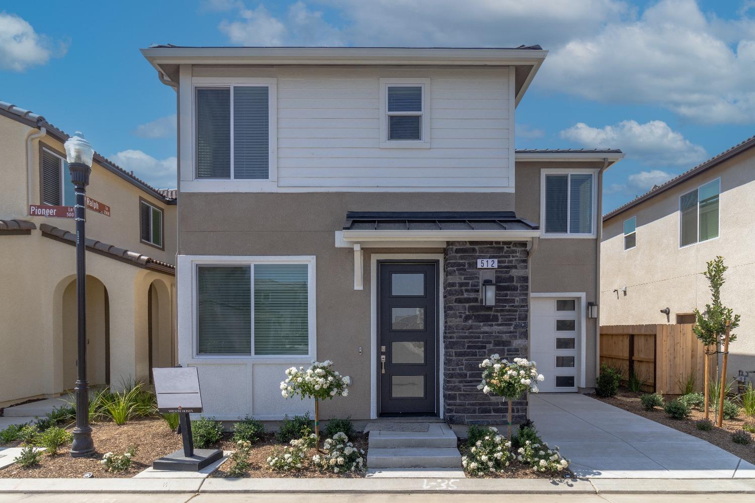 a front view of a house with garden