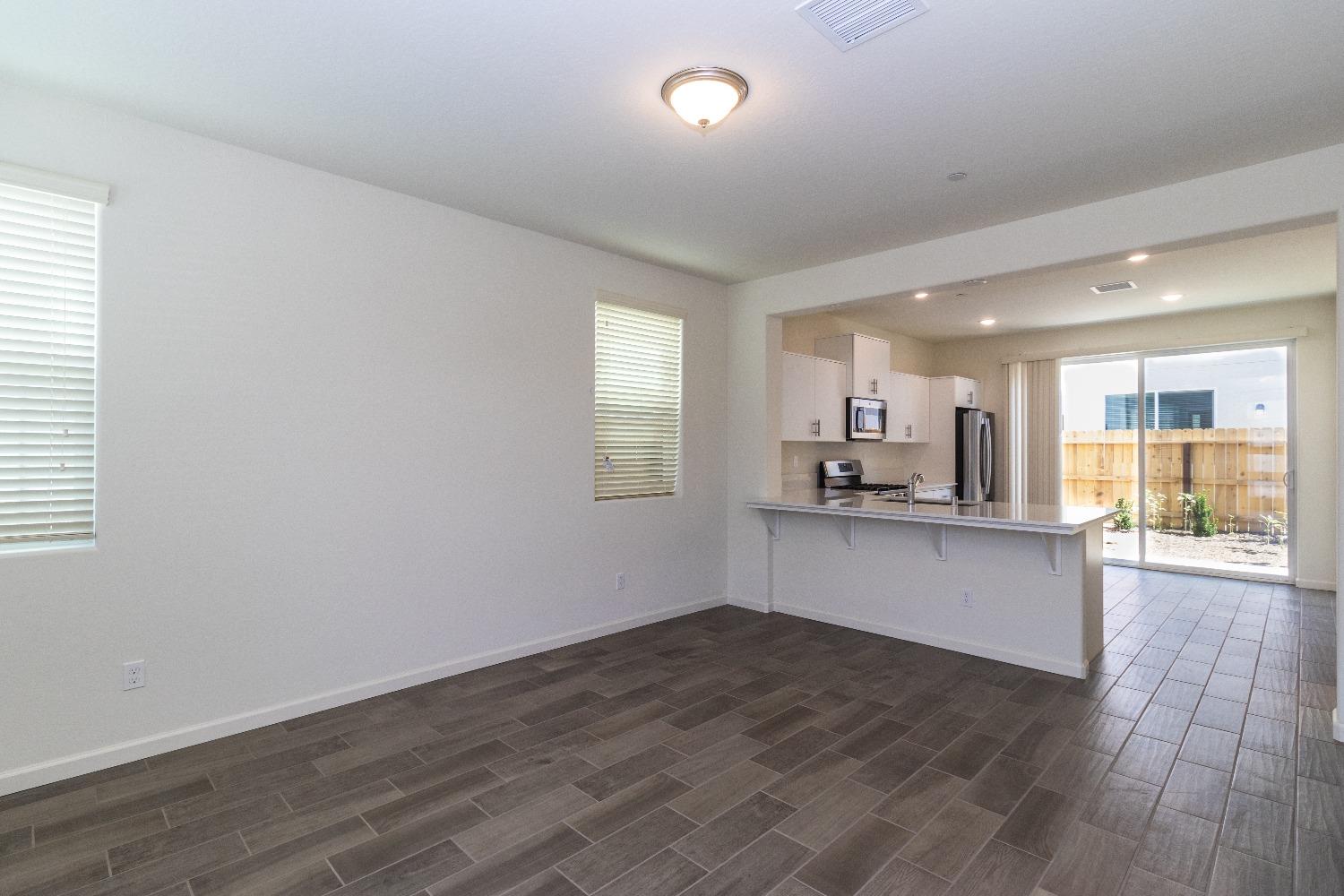 512 Pioneer Lane Clovis, CA 93619 - Photo 3 of 17 a large kitchen with a wooden floor and a window