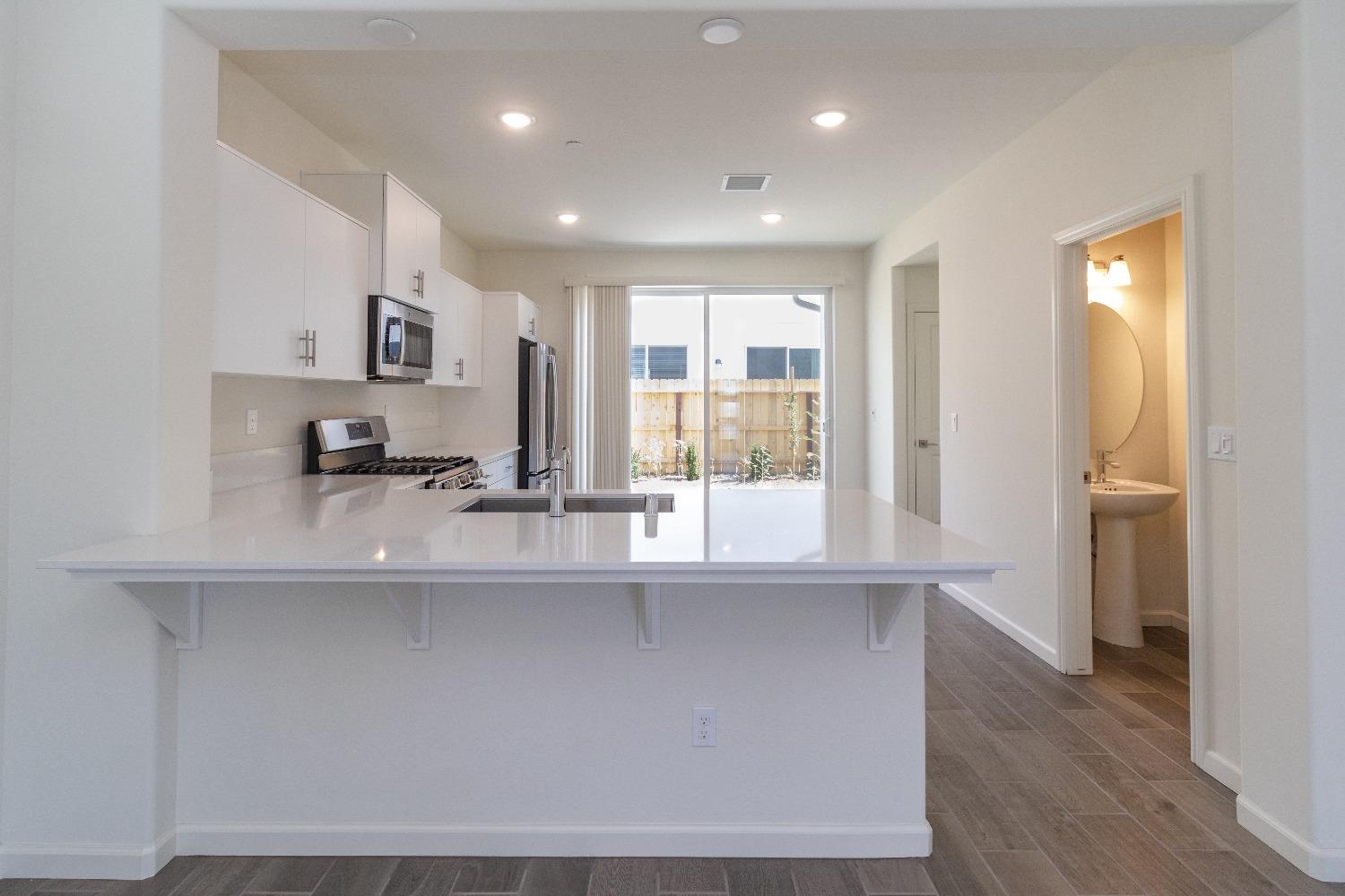 512 Pioneer Lane Clovis, CA 93619 - Photo 4 of 17 a kitchen with stainless steel appliances a sink and a refrigerator