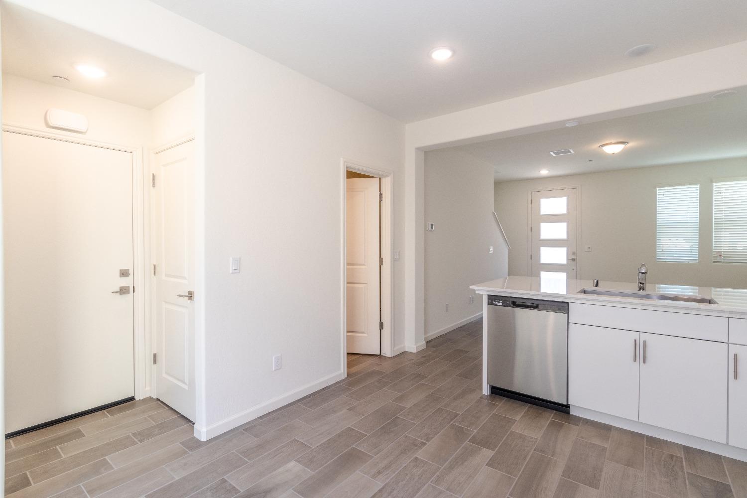 512 Pioneer Lane Clovis, CA 93619 - Photo 7 of 17 a view of a kitchen with sink cabinets and wooden floor