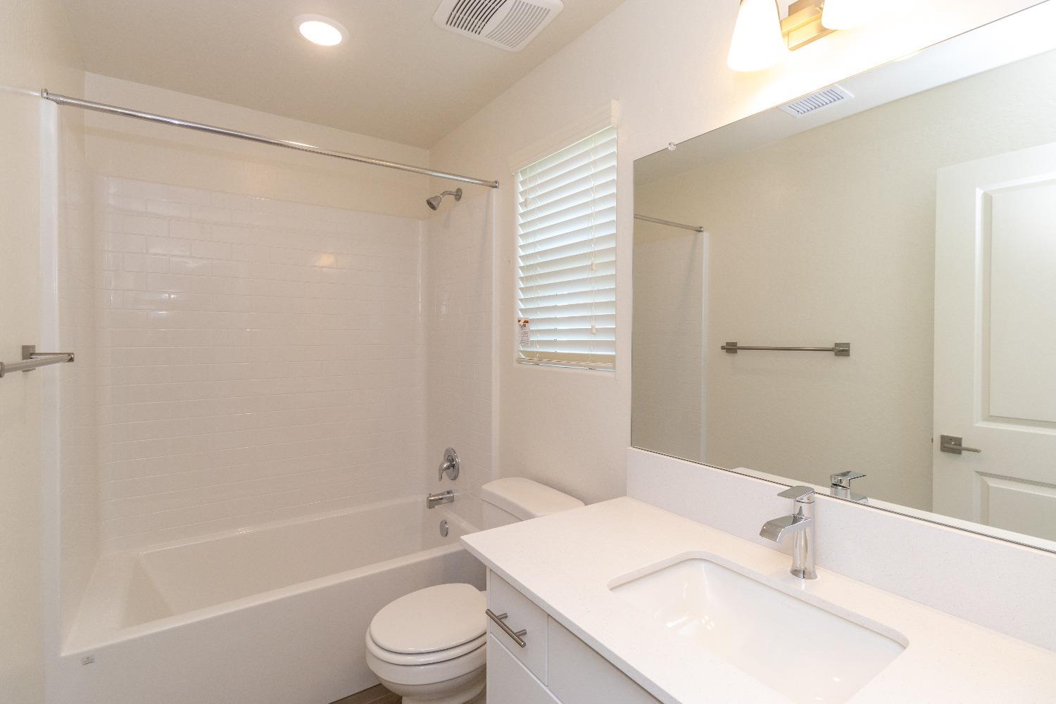 512 Pioneer Lane Clovis, CA 93619 - Photo 10 of 17 a bathroom with a granite countertop sink toilet and shower