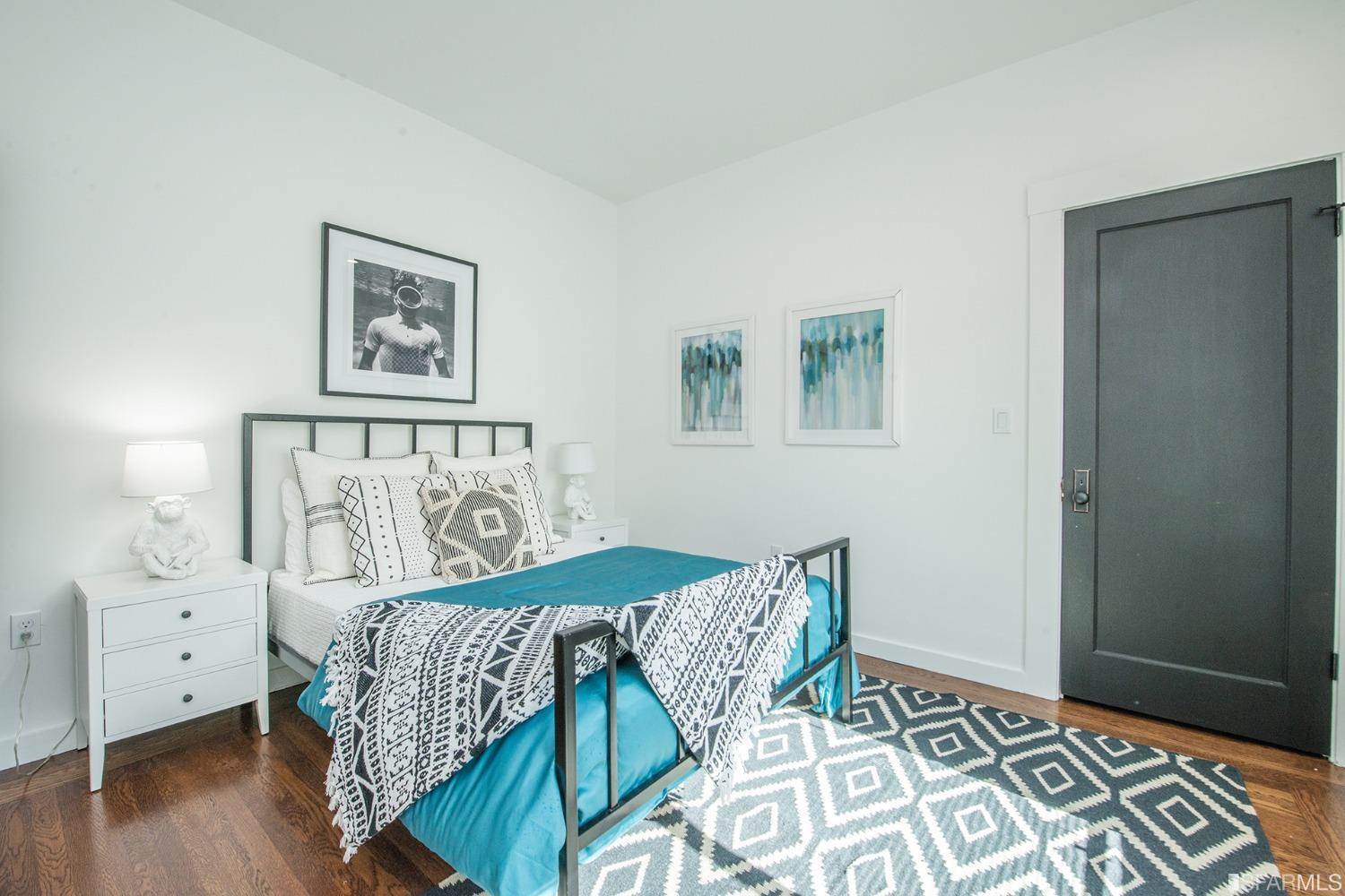 2422 Bonar Street Berkeley, CA 94702 - Photo 11 of 54 a bedroom with a bed and a table in it