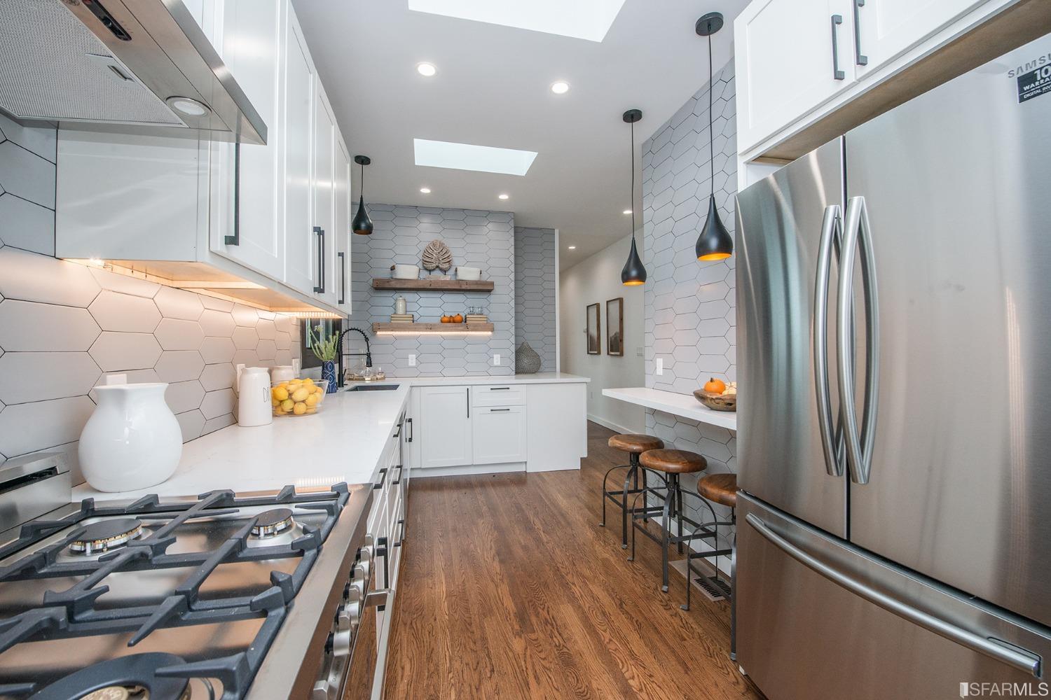 2422 Bonar Street Berkeley, CA 94702 - Photo 17 of 54 a kitchen with stainless steel appliances granite countertop a refrigerator a stove and a wooden floors