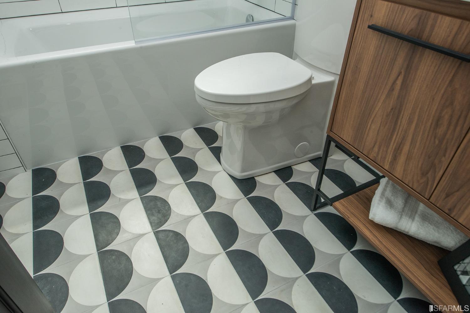 2422 Bonar Street Berkeley, CA 94702 - Photo 30 of 54 a white toilet sitting next to a shower curtain