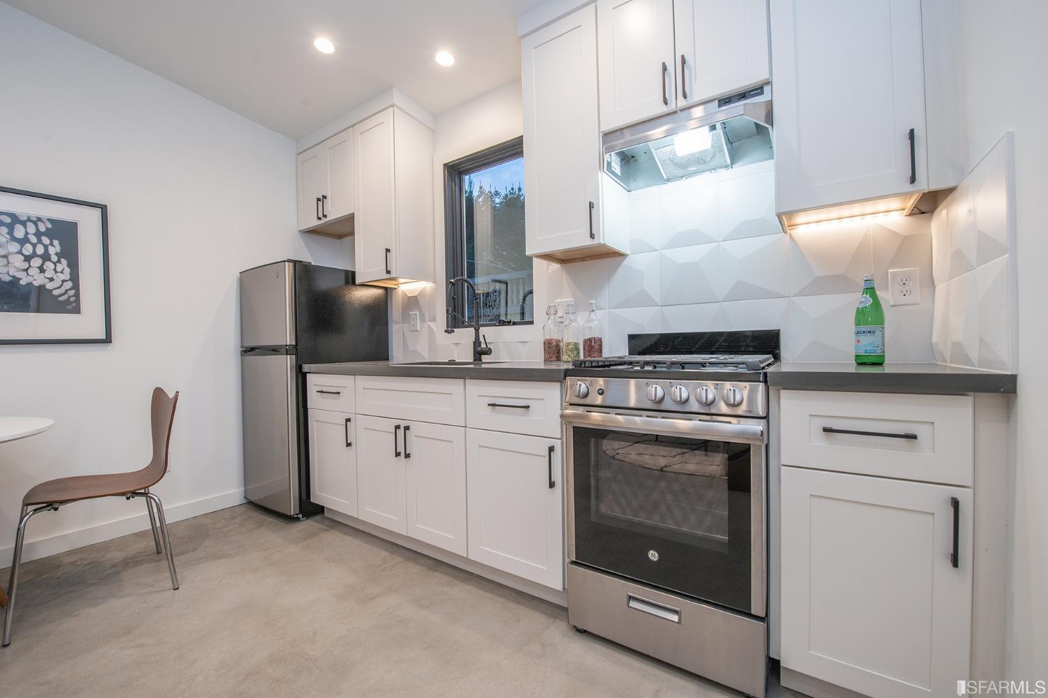 2422 Bonar Street Berkeley, CA 94702 - Photo 49 of 54 a kitchen with a stove oven and white cabinets