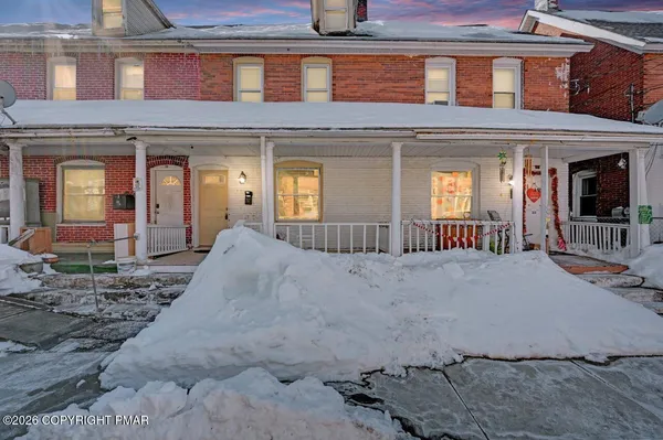 a view of a brick house with large windows