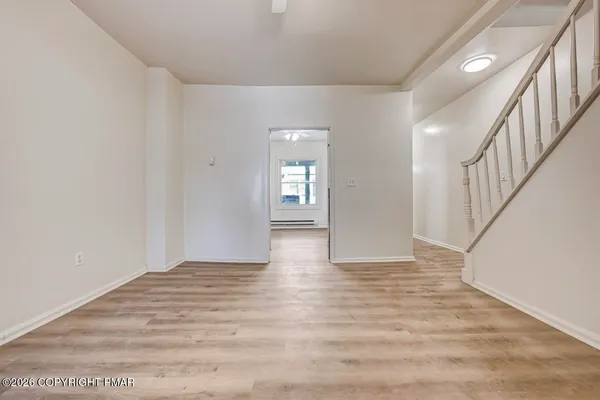 wooden floor in an empty room with a window