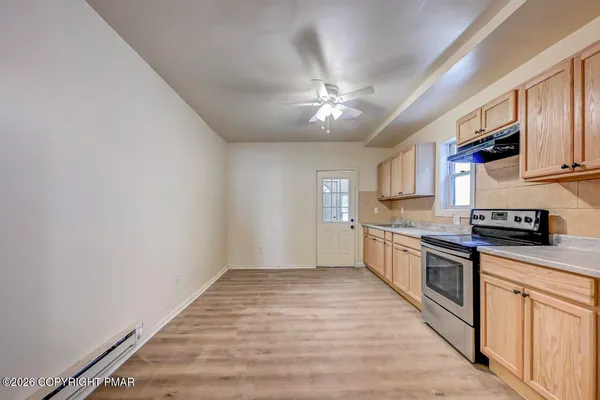 a view of an entryway with wooden floor
