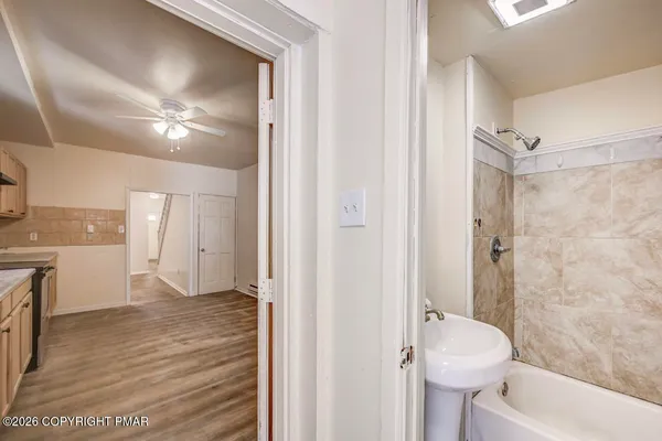 a bathroom with a bathtub and a shower