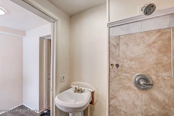 a view of a bathroom from a hallway