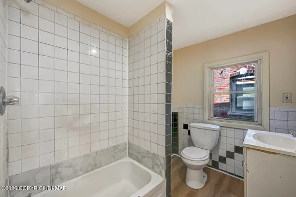a white toilet sitting next to a bathroom sink