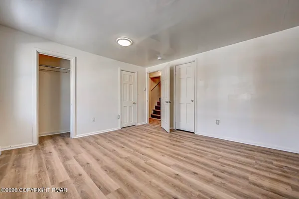 a view of a hallway with wooden floor