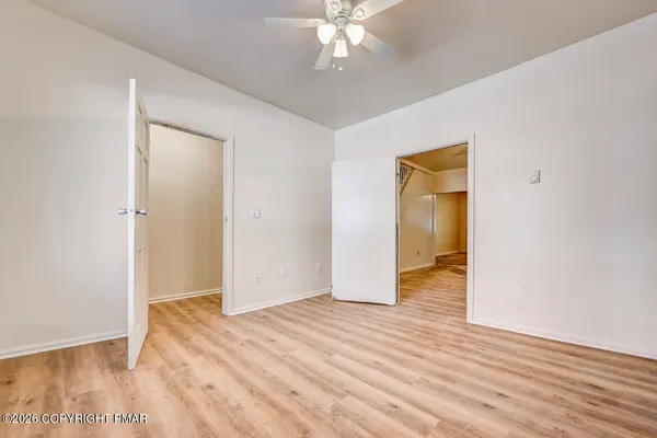 a view of an empty room with wooden floor