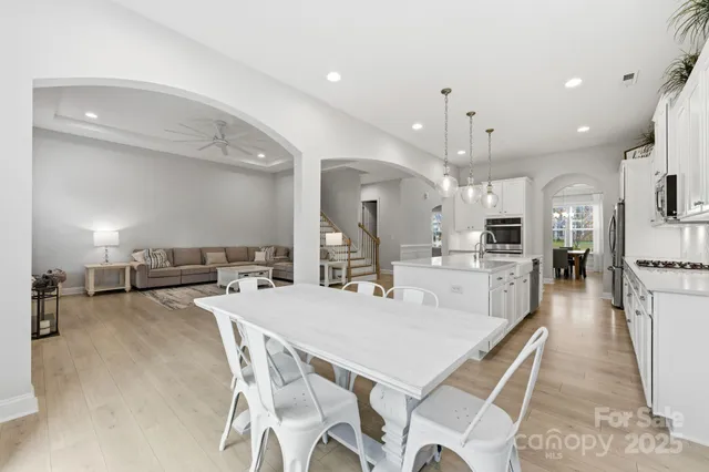 a large kitchen with a table and chairs