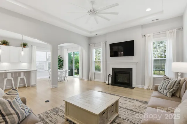 a living room with furniture fireplace and flat screen tv