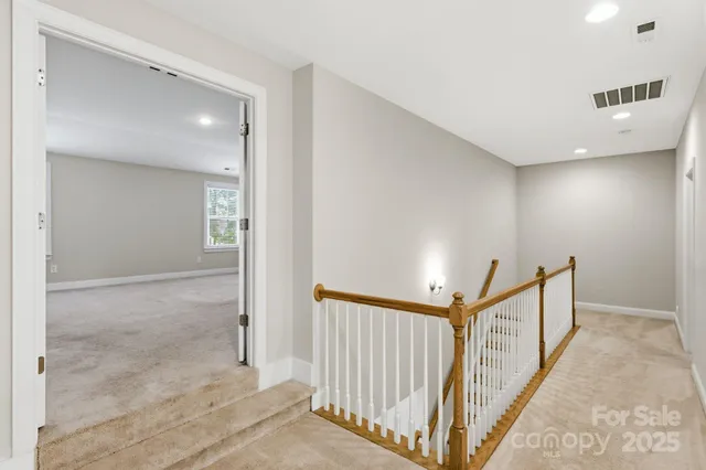 a view of a hallway with stairs