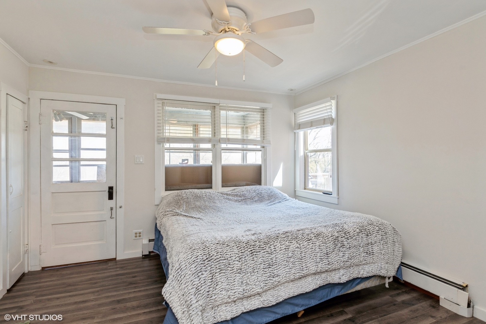 28660 Golf View Drive Spring Grove, IL 60081 - Photo 14 of 25 a bedroom with a large bed chandelier and wooden floor