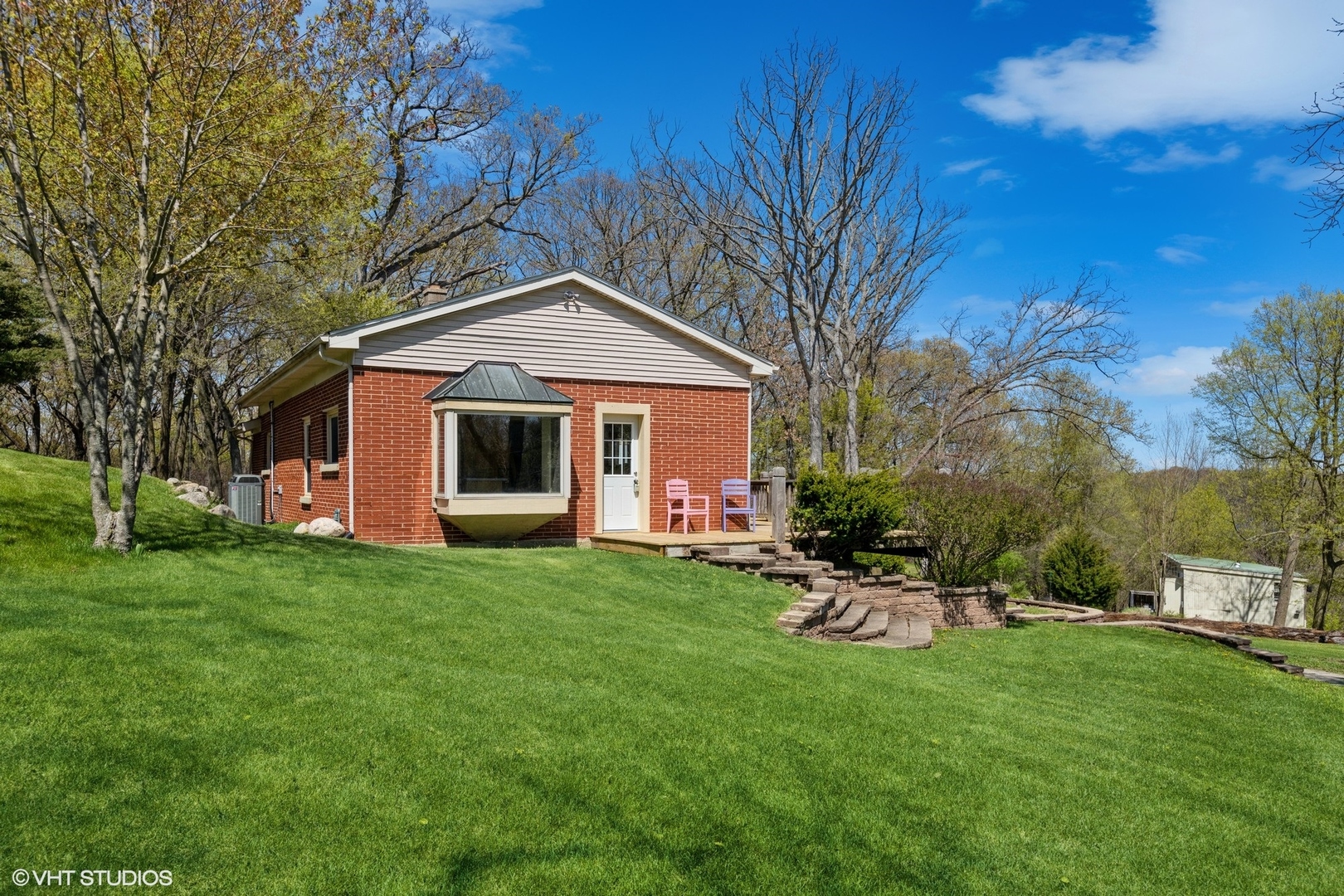 28660 Golf View Drive Spring Grove, IL 60081 - Photo 3 of 25 a front view of a house with a garden and trees
