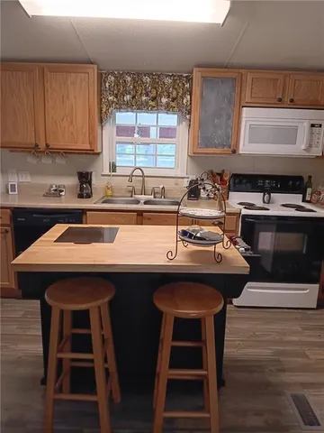 a kitchen with a sink a stove a dining table and chairs